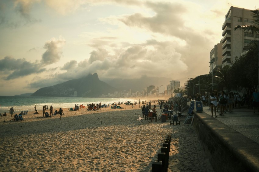 a group of people standing on top of a sandy beach