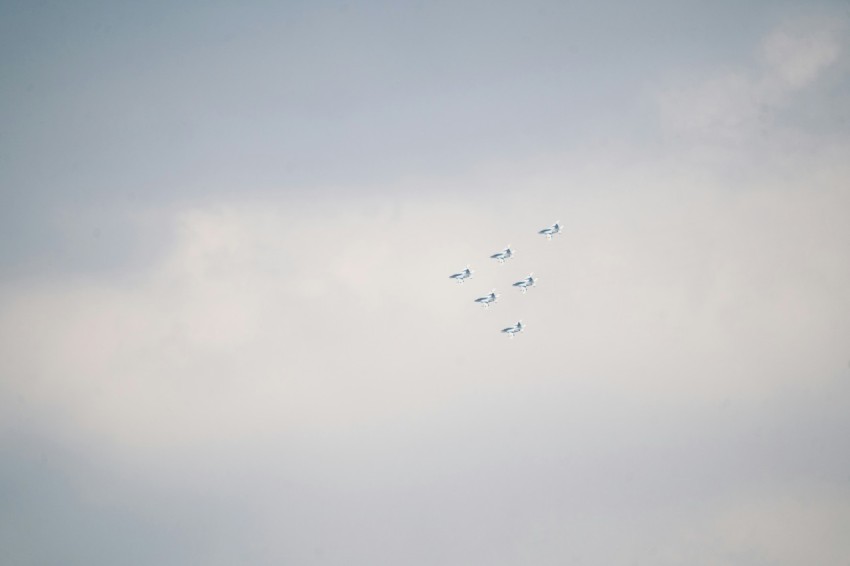 a group of airplanes flying through a cloudy sky