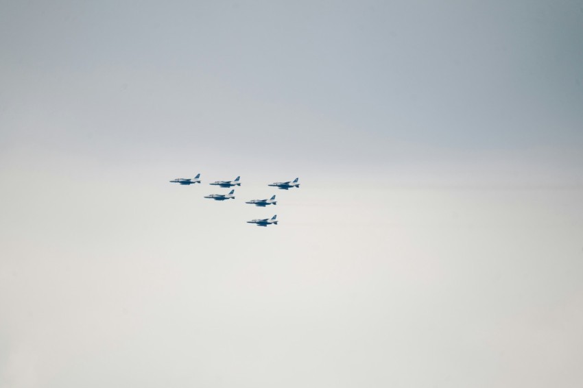 a group of fighter jets flying in formation