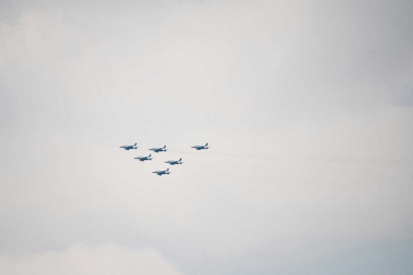 a group of planes flying in formation in the sky