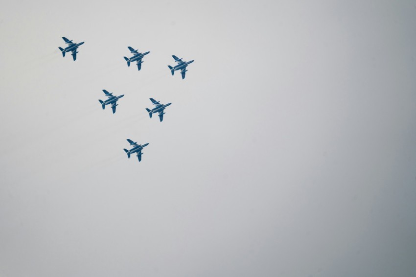 a group of planes flying in formation in the sky wQqZF