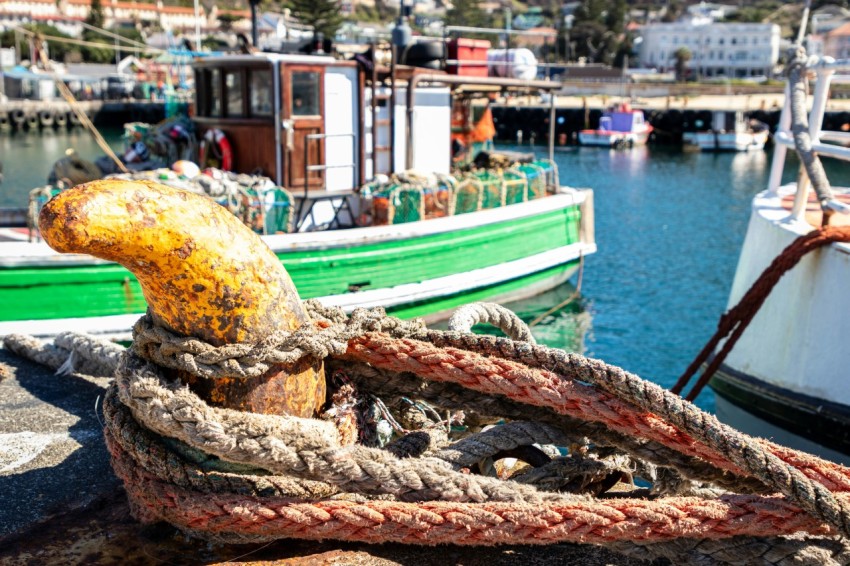 a boat docked in a harbor with other boats