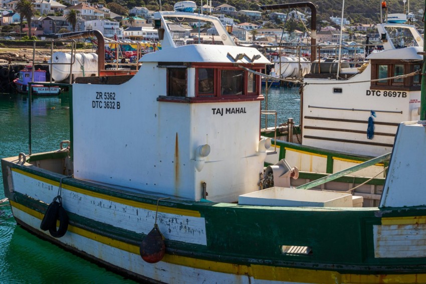 a boat is docked in a harbor with other boats