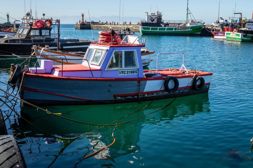 a group of boats floating on top of a body of water