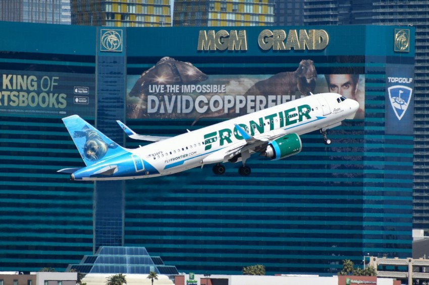 a large passenger jet flying over the las vegas strip