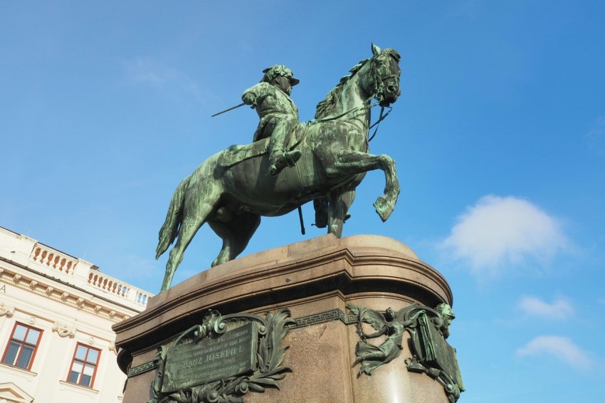 a statue of a man on a horse in front of a building E