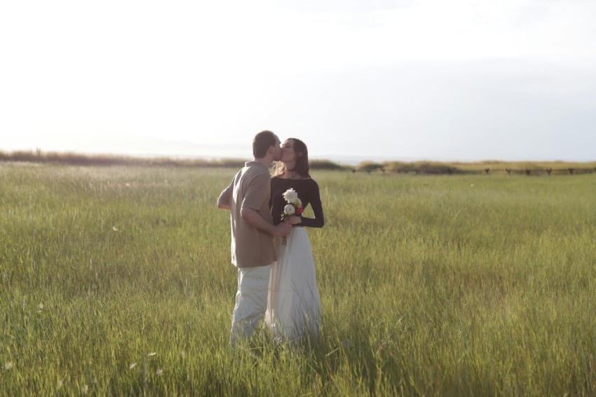 a man and a woman are standing in a field