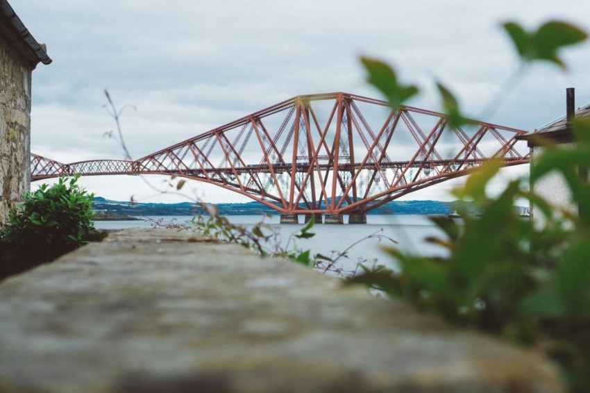 a red bridge crossing over a body of water