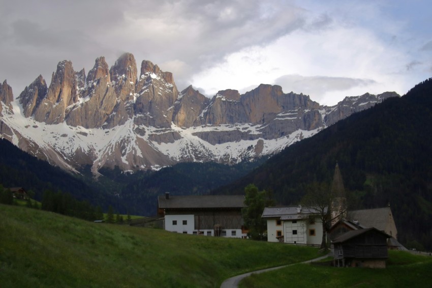 a mountain range with a house in the foreground