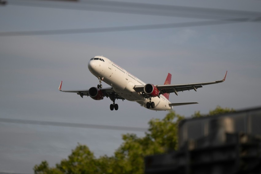 a large jetliner flying through a cloudy sky