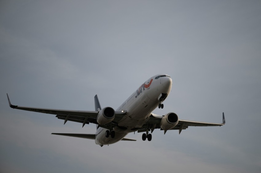 a large passenger jet flying through a cloudy sky