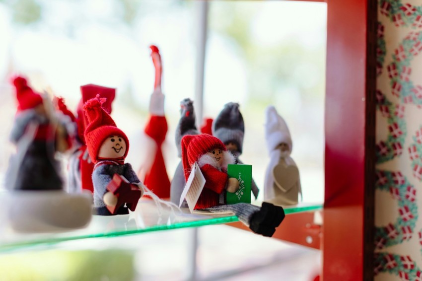 a group of gnome figurines sitting on top of a glass shelf