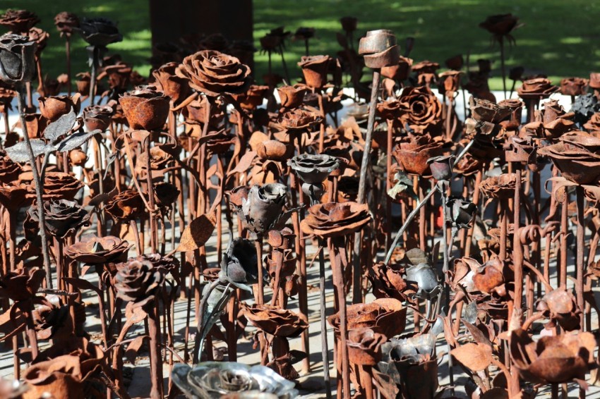 a large pile of rusted metal objects in a park