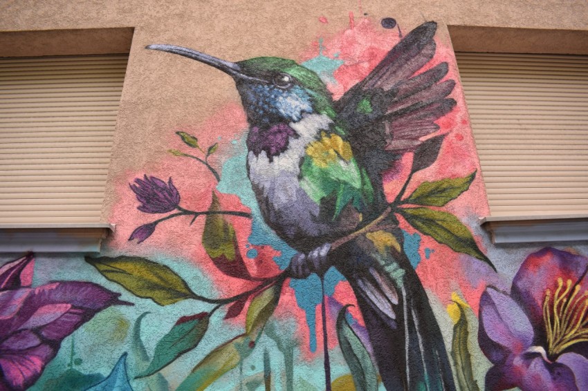 a painting of a hummingbird on a wall