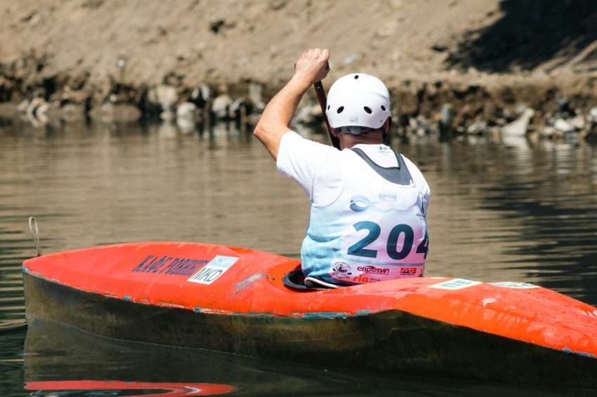 a person in a kayak on a body of water Lop