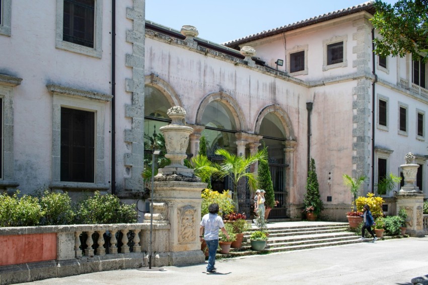 a man standing in front of a large building