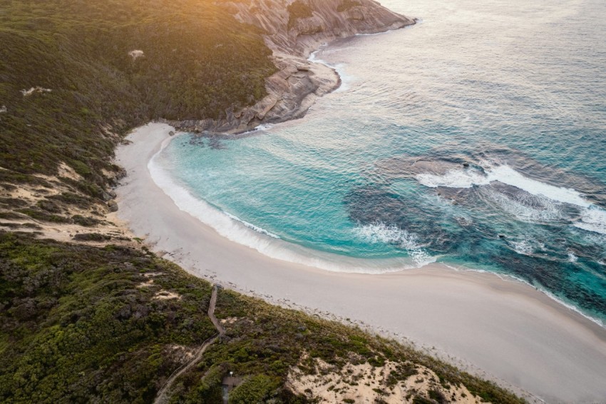 an aerial view of a sandy beach and ocean