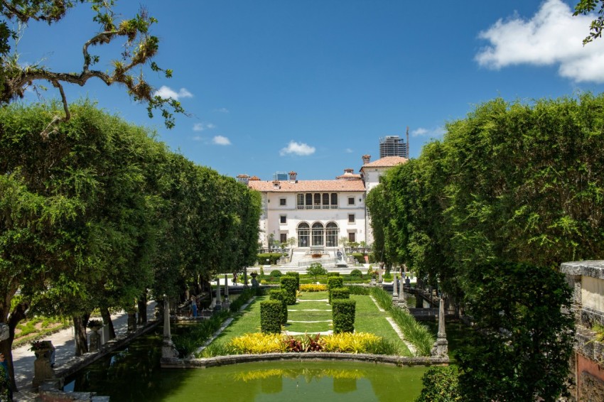 a view of a large building with a garden in front of it