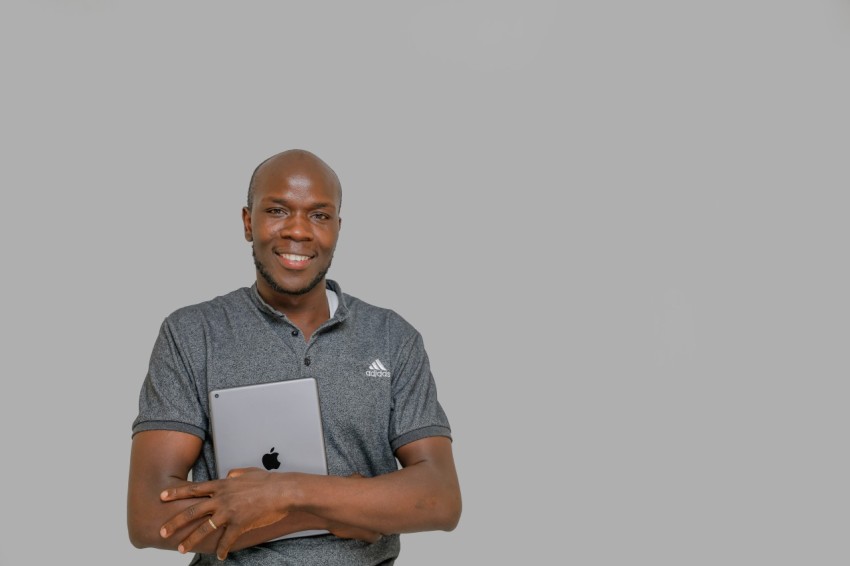 a man holding a laptop computer in his hands