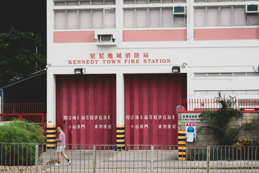 a red and white building with a person walking in front of it