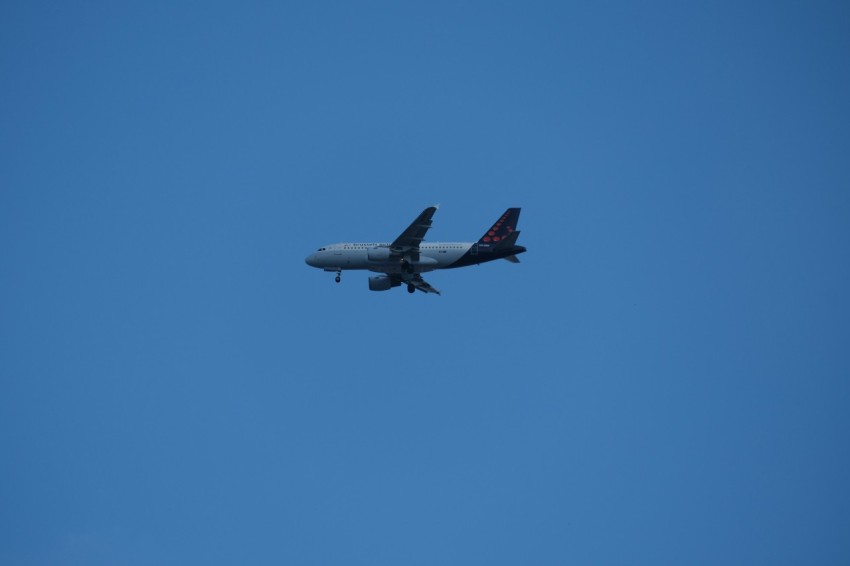 an airplane is flying in the blue sky