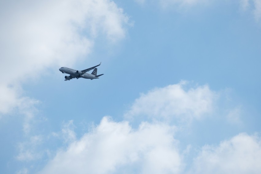 an airplane is flying through the blue sky