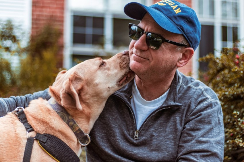 dog licking mans neck