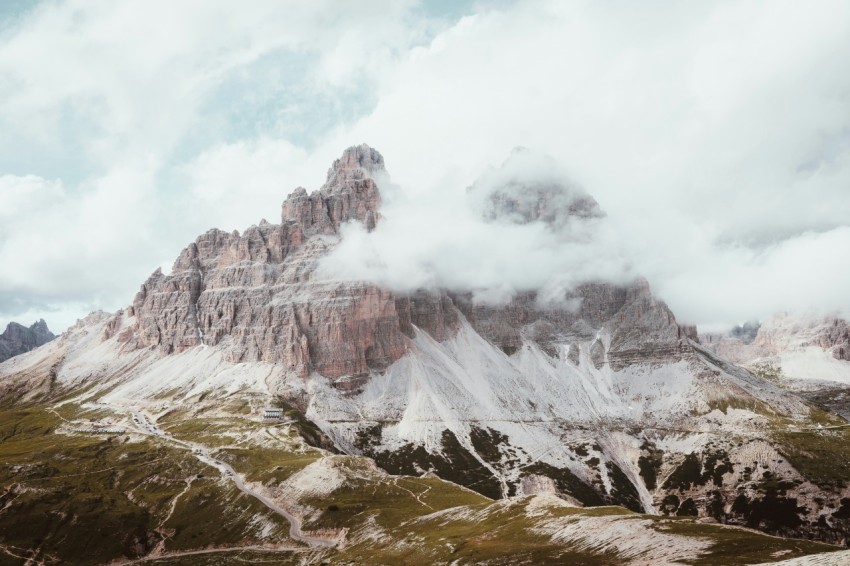 a mountain range covered in clouds and snow