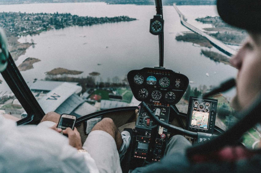 two persons riding helicopter