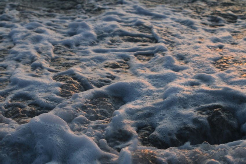 a beach covered in snow at sunset Pj