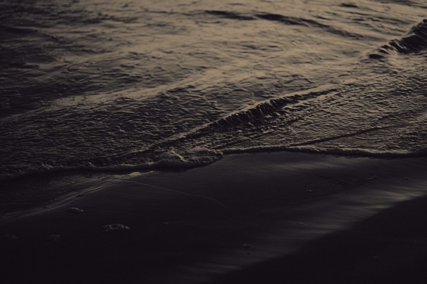 a black and white photo of the ocean waves