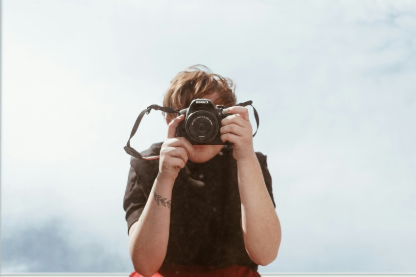 person holding black dslr camera