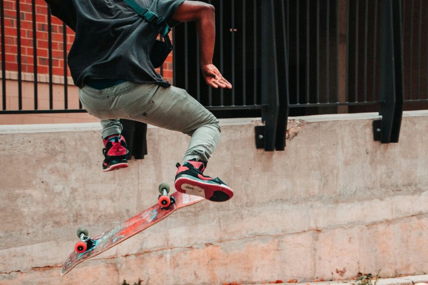 person skateboarding near fence