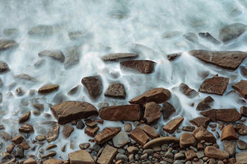 brown rocks on body of water