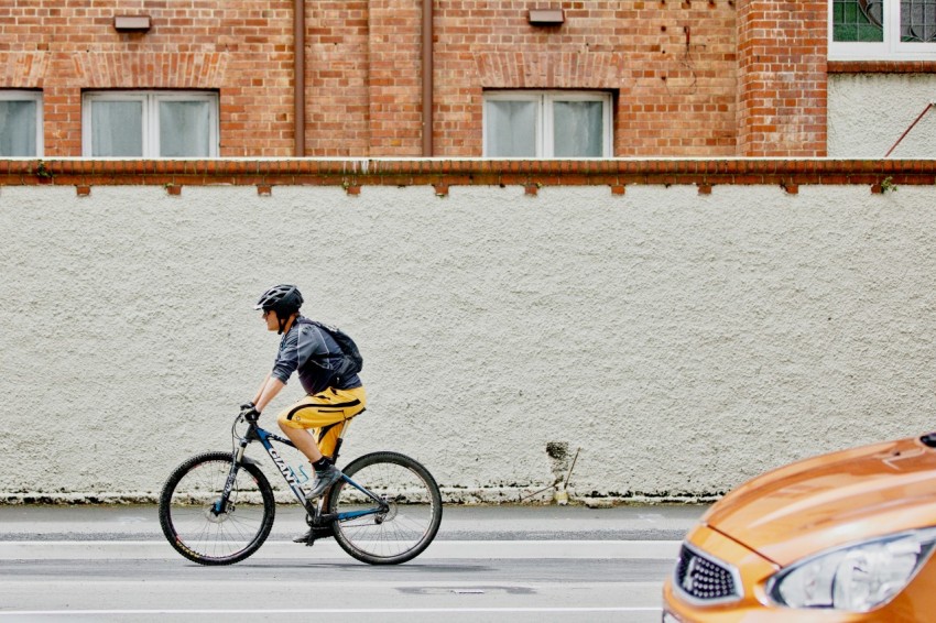 man riding black bike on street 1rsskca11