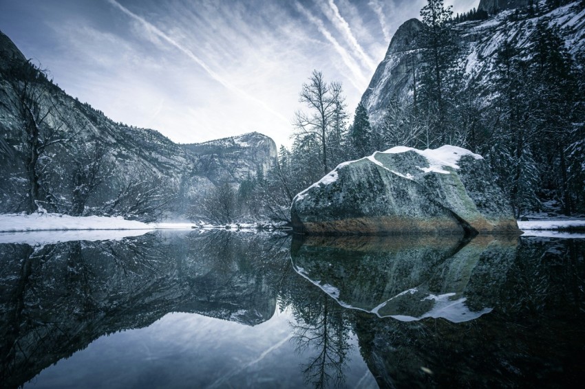 body of water near snow covered mountain during daytime