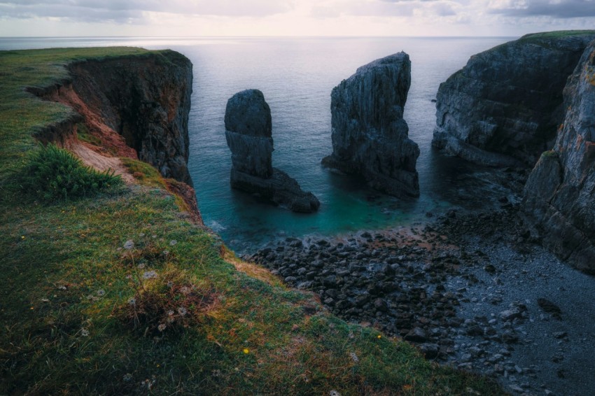 sea stack beside cliff in wales