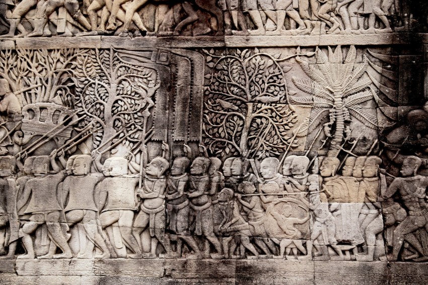 people holding spear embossed wall