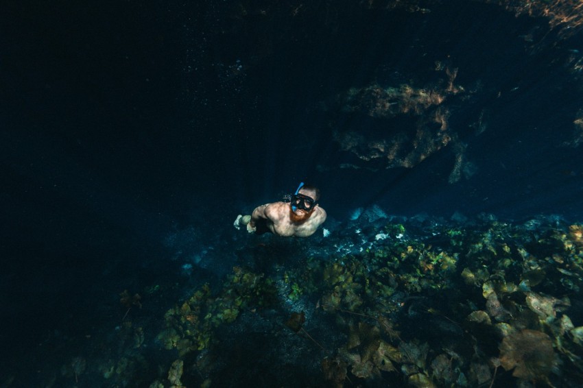 man free diving in clear water