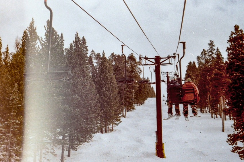 red cable car over snow covered ground