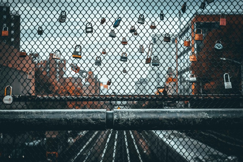 a view through a chain link fence at a train yard