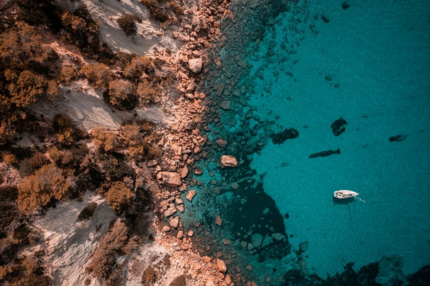 an aerial view of a boat in the water