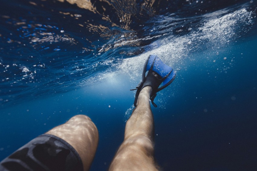 a persons feet are submerged in the water