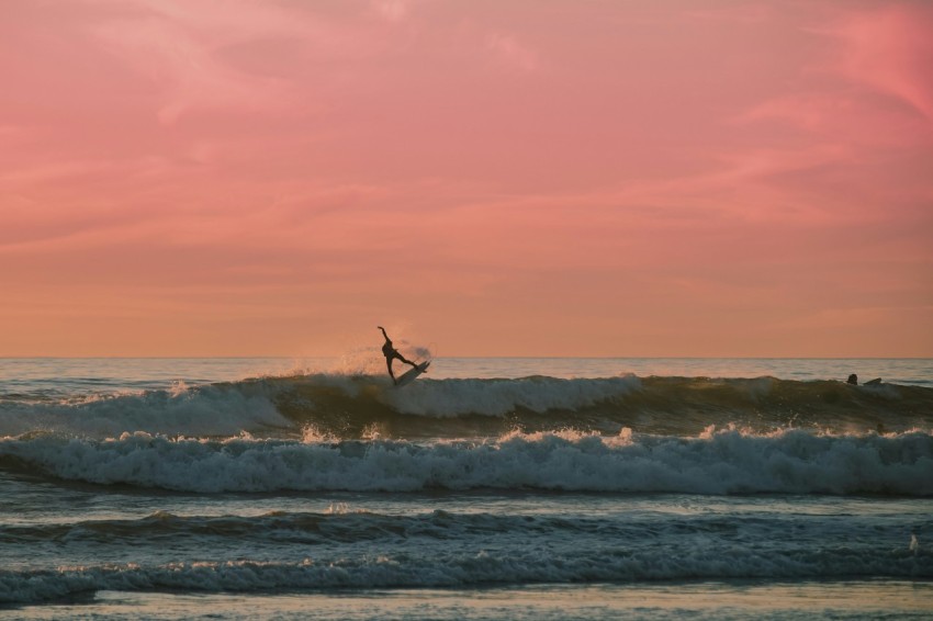 a person riding a wave on top of a surfboard