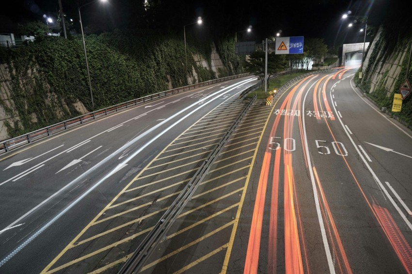 concrete road with street lights during nighttime