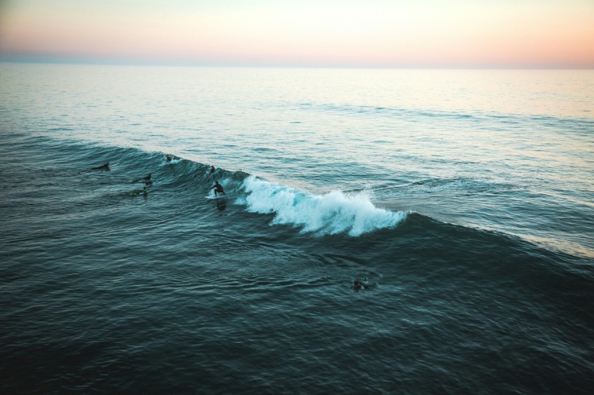 man surfing on wave eNI