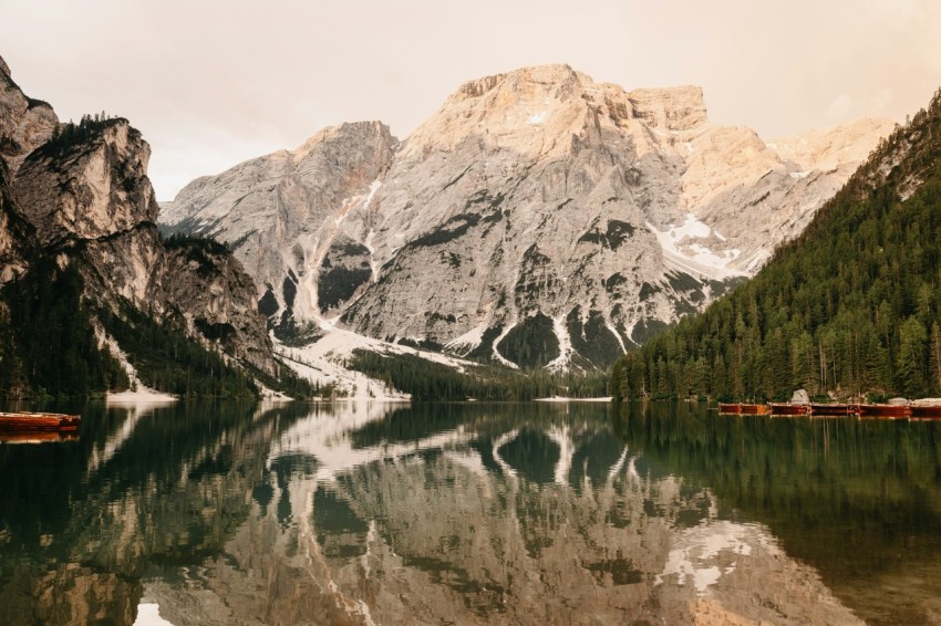 snow covered mountain near body of water during daytime