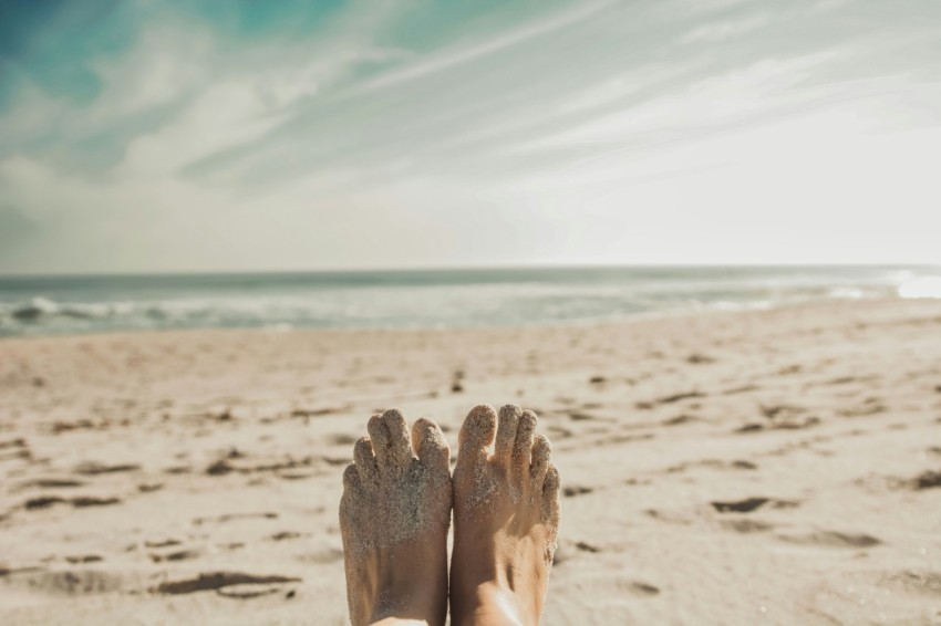 persons feet covered with sand eNljP