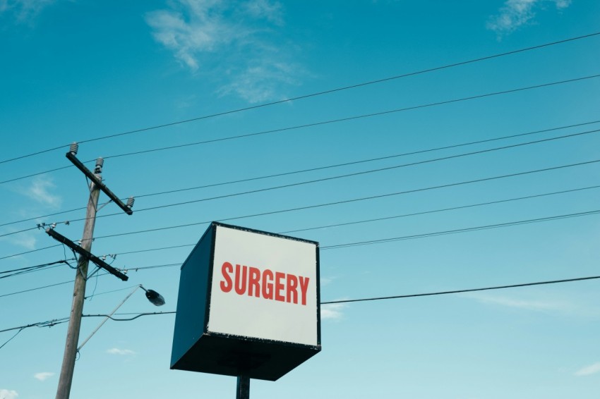 surgery building sign near electric post