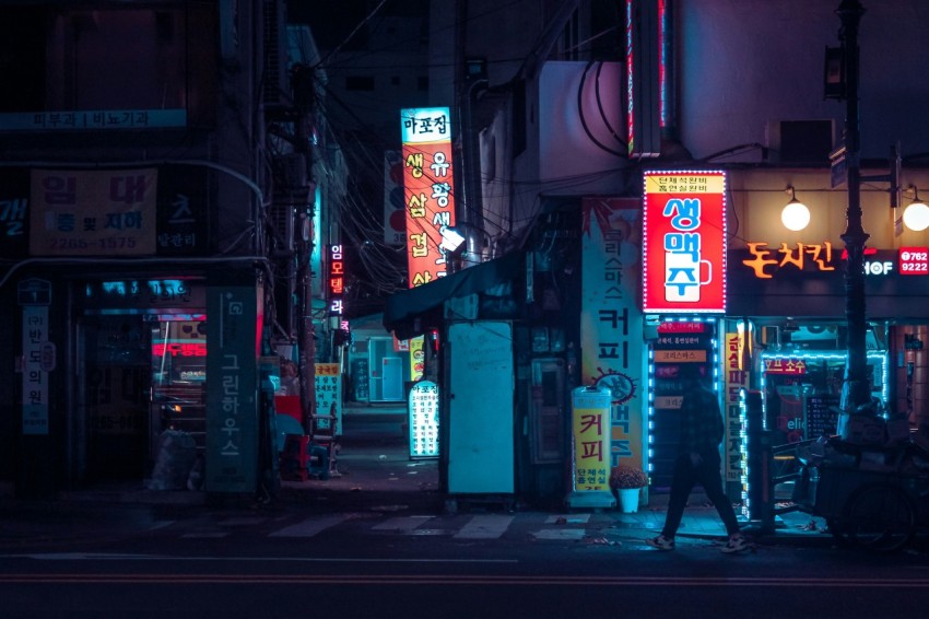 a person walking down a street at night